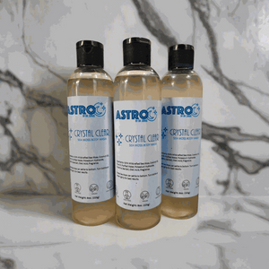 Astro Crystal Clear Sea Moss Body Wash bottles arranged on marble surface, featuring mineral-rich natural ingredients.