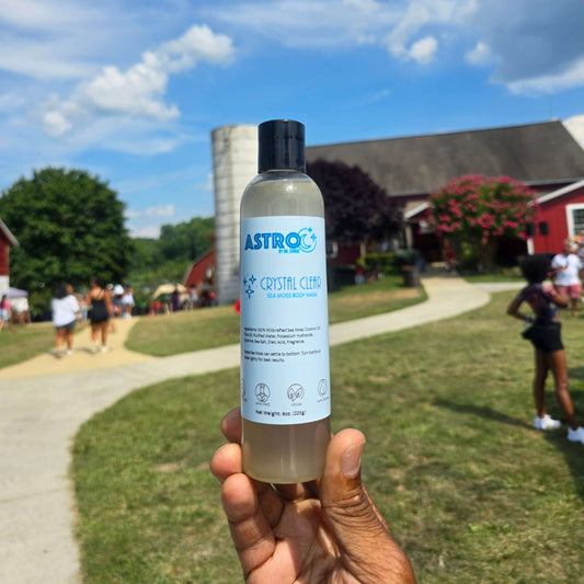 Astro Body Wash Crystal Clear Sea Moss infused natural moisturizing body wash in clear plastic bottle held outdoors