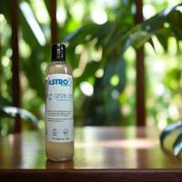 Astro Sea Moss Body Wash bottle on wooden surface with green plants background, natural skincare product.