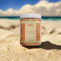 Astro Brand Solar Strength gold sea moss gel in a clear jar on sandy beach background.