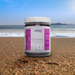 Star Shield Purple Sea Moss Gel 16oz jar on beach background.